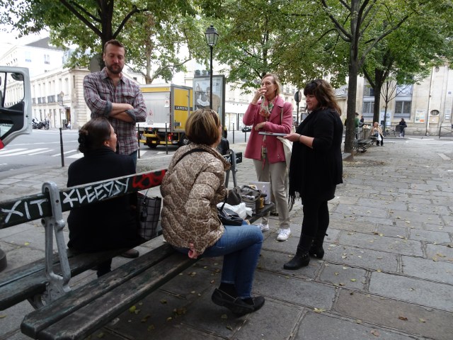 The docent speaking to the small group on a Context Travel food tour.