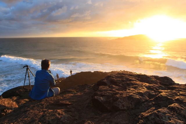 A man looking at sunset from a beach in Australia 