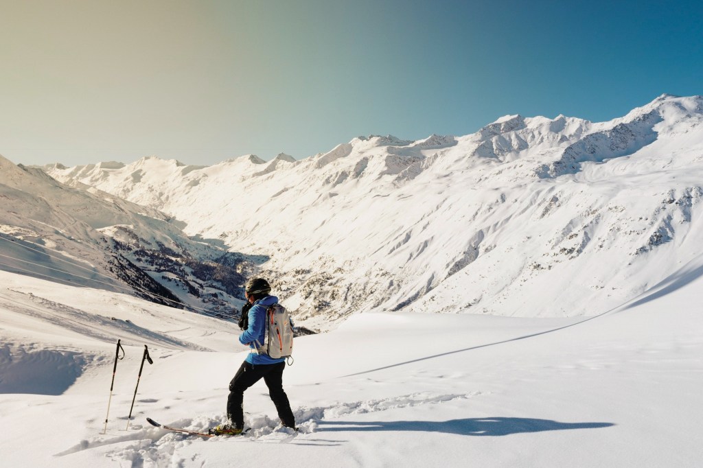 Skier in a blue jacket and black pants