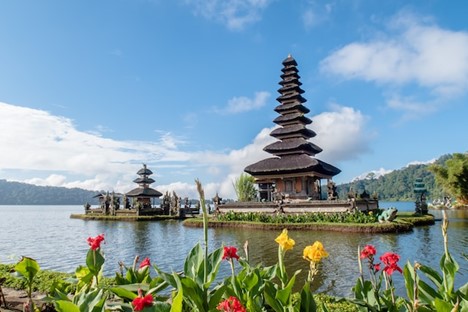 A big temple on a lake in Bali viewed when traveling for wellness