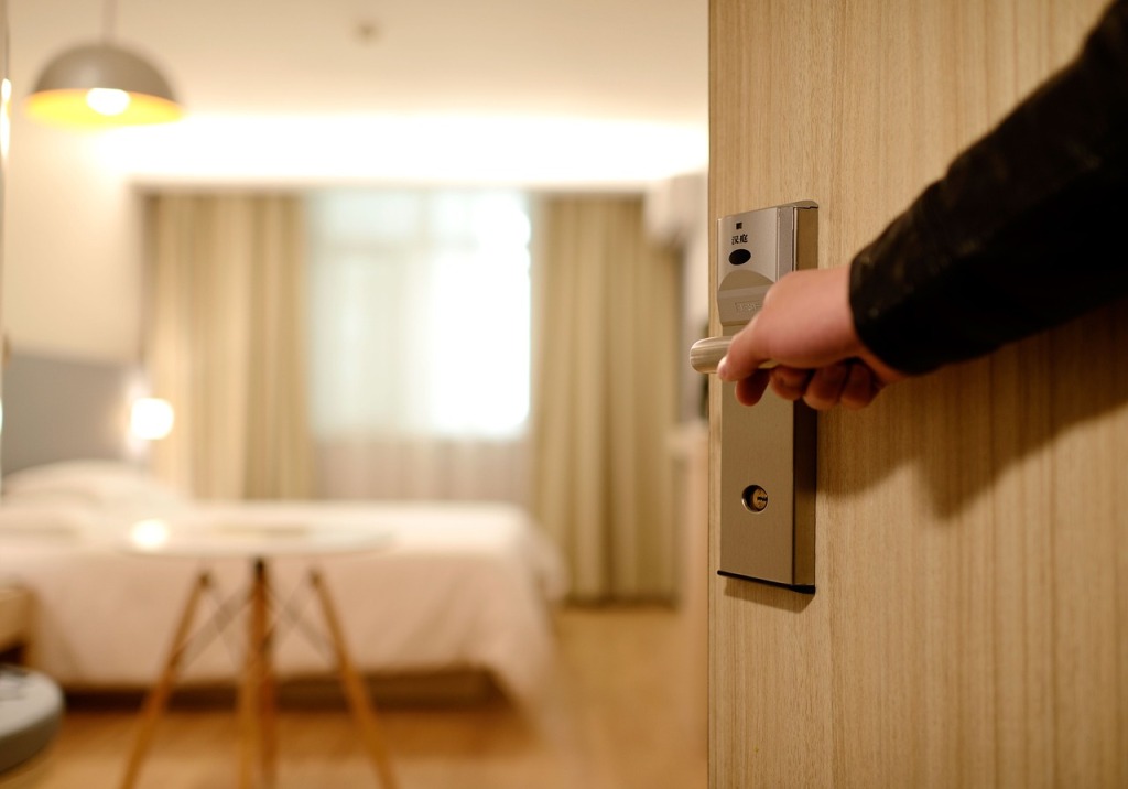 Opening the door of a hotel room.