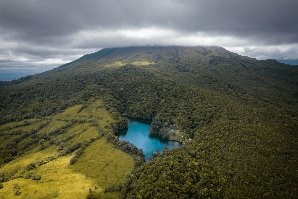 A blue lake surrounded by trees and mountains in Costa Rica 
