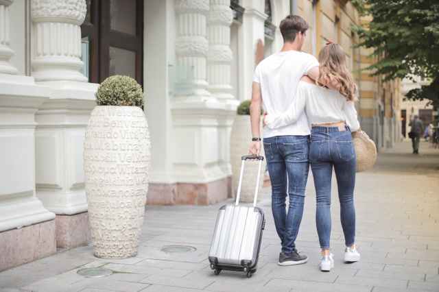 2 people with a suitcase