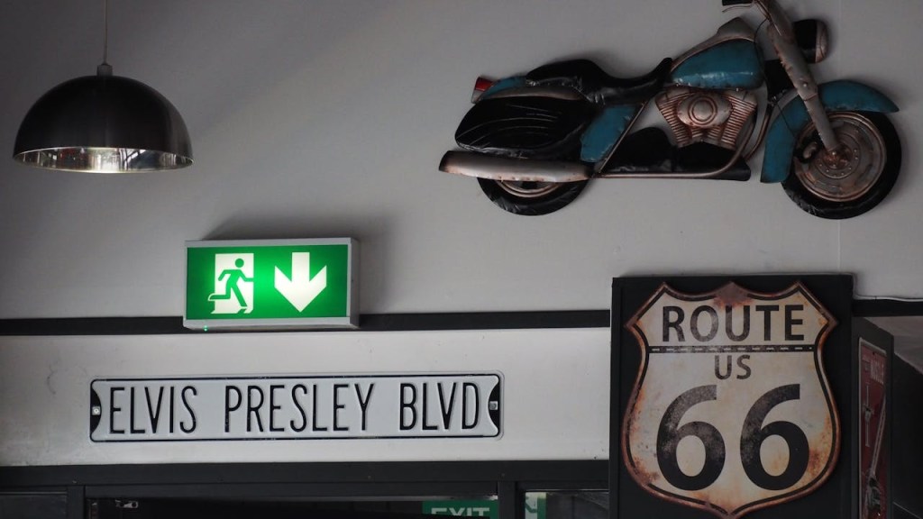 A Route 66 sign and a sign on the wall.