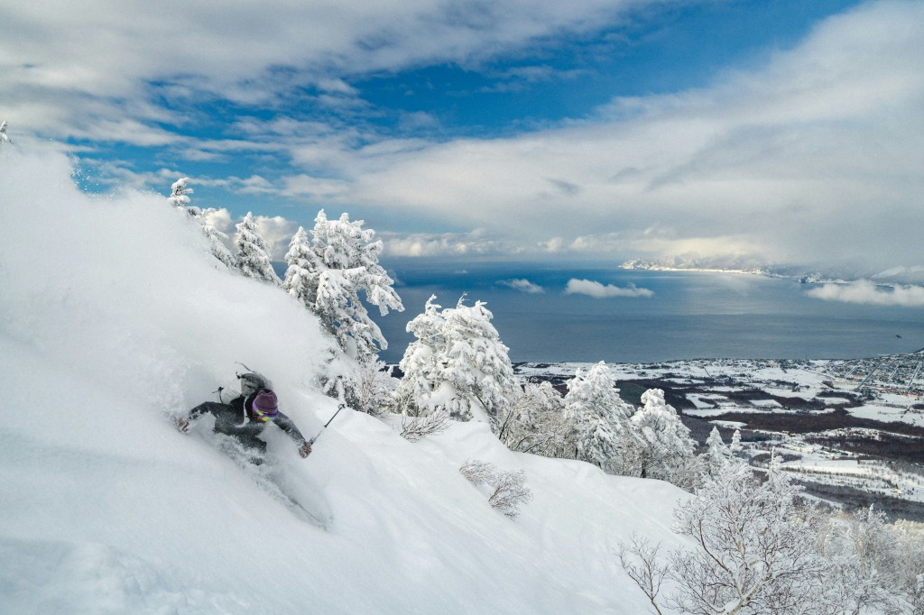 A skier racing down the slopes in Niseko.