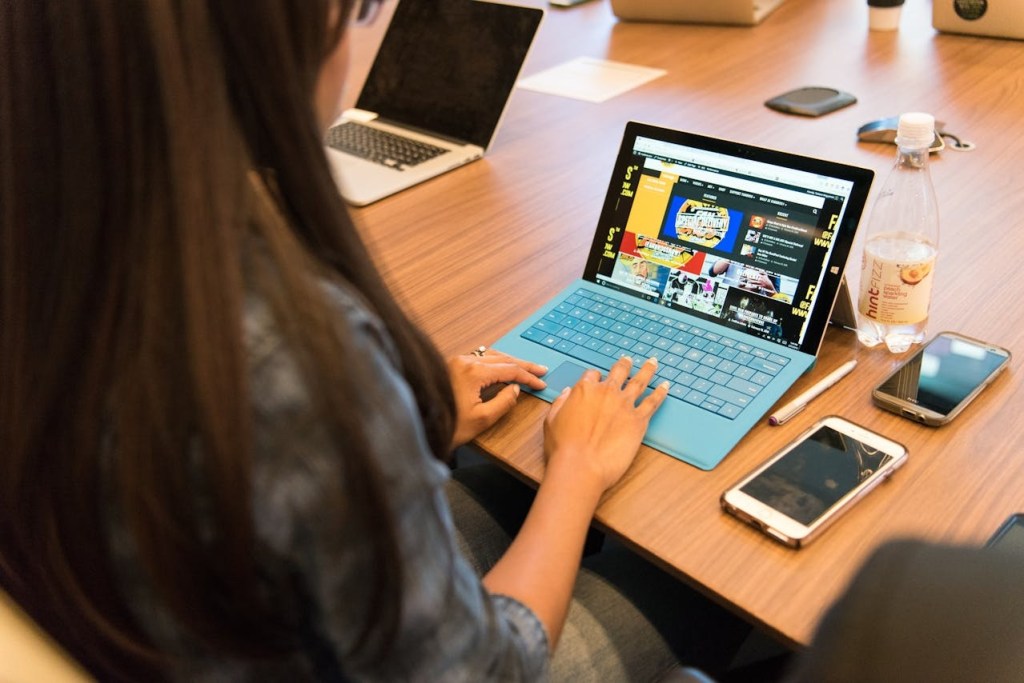 woman using a laptop at an airport